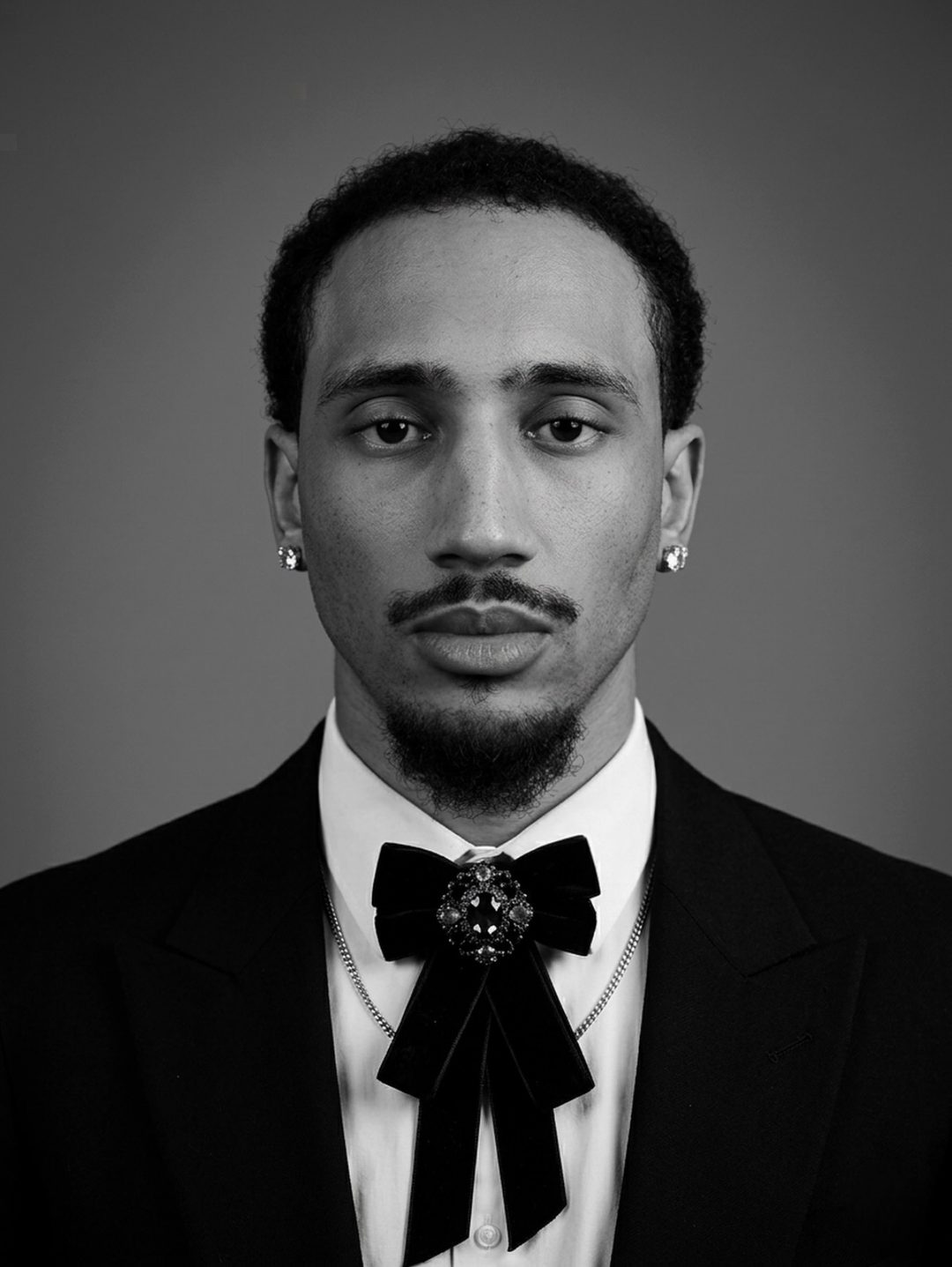 Aaron Fife black-and-white editorial portrait in a tuxedo and bow tie