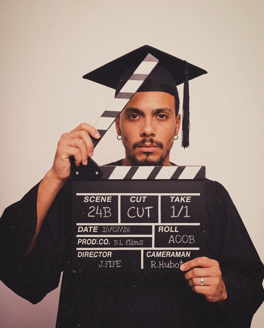 Jordan Fife holding a film clapperboard as director on a GTTM shoot