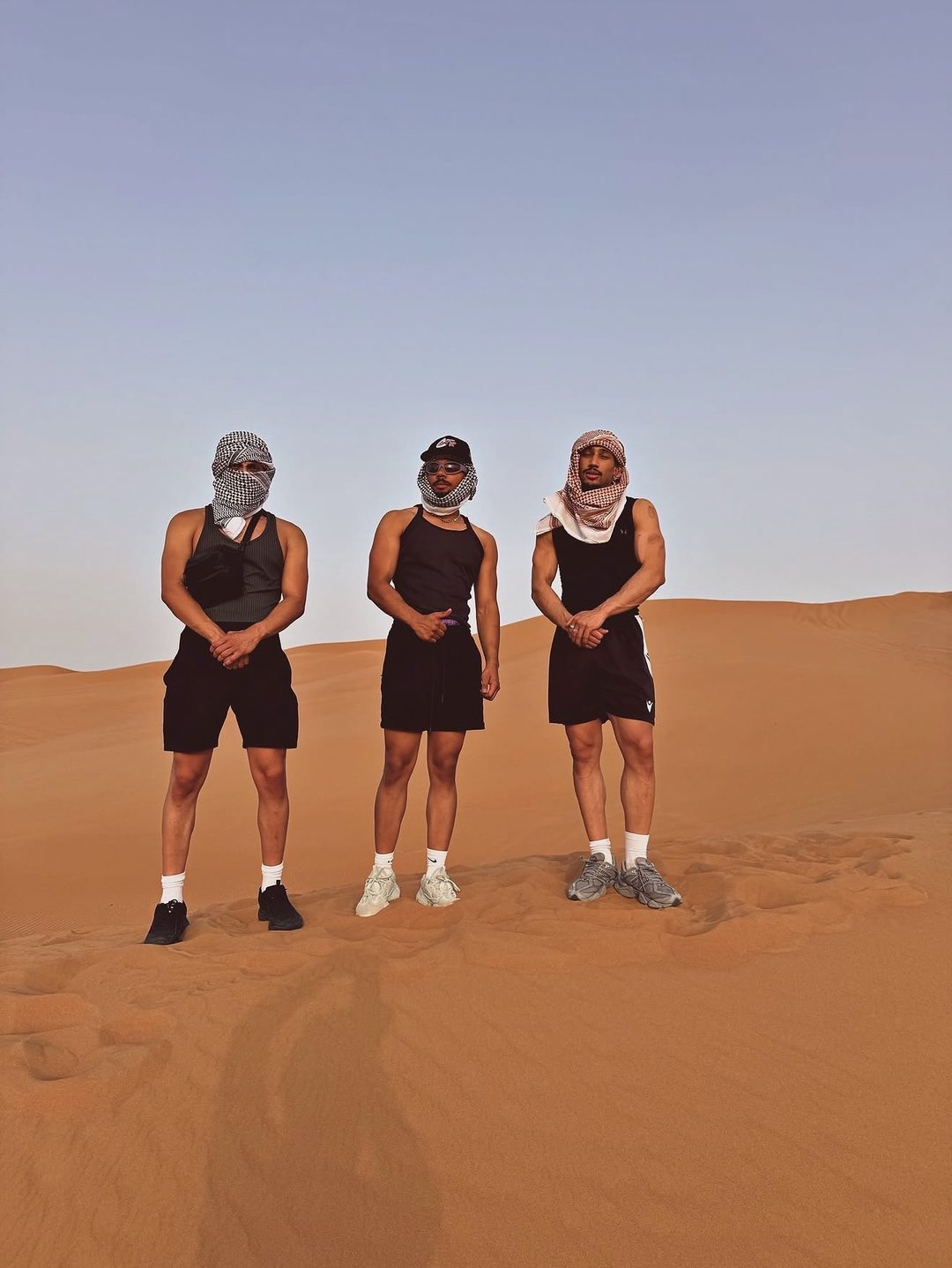 The Fife Brothers standing on the sand dunes during a Dubai desert trip