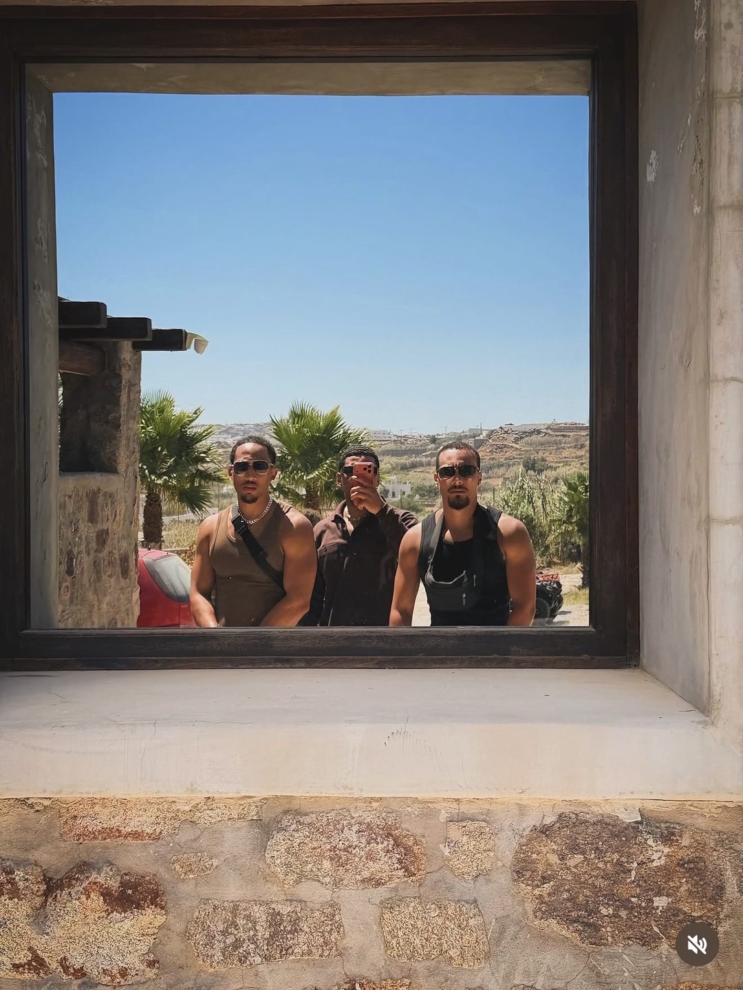 The Fife Brothers reflected in a window on a summer trip in Greece